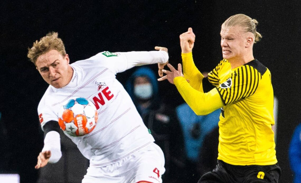 Koln defender Timo Hubers battling Dortmund striker Erling Haaland