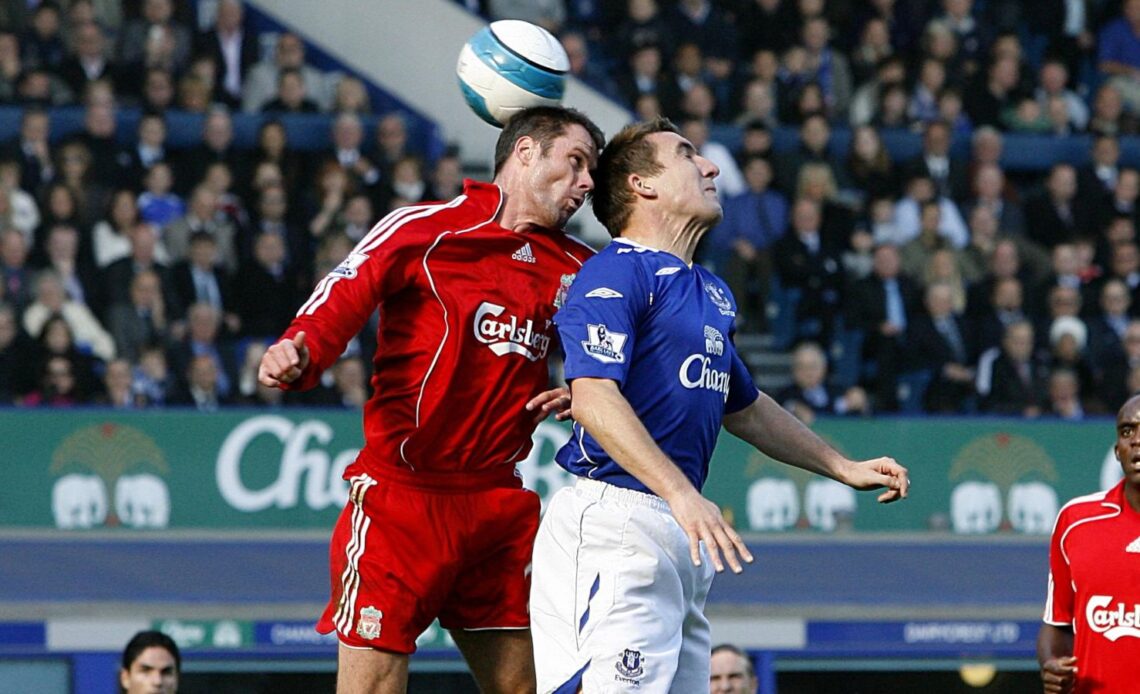 Everton defender Alan Stubbs and Jamie Carragher go up for a header