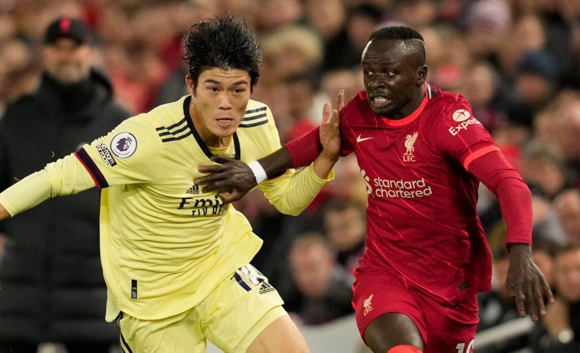 Takehiro Tomiyasu defends against Liverpool's Sadio Mane