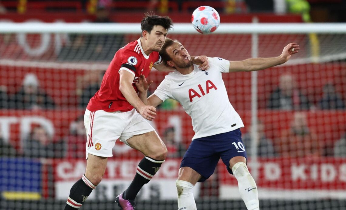 Harry Maguire heads the ball away from Tottenham striker Harry Kane