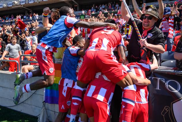 Atlético Ottawa pile on after Zach Verhoven's goal against Pacific FC