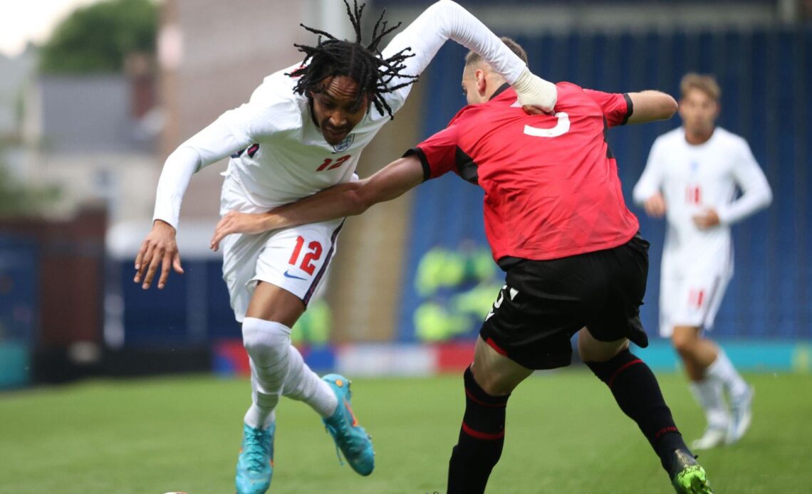 Tottenham signing Djed Spence knocks the ball past an opponent