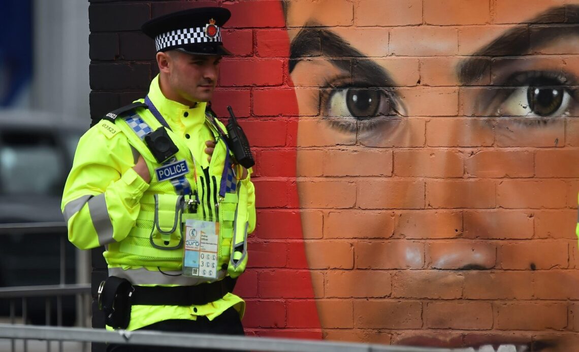 Policeman in front of a Ronaldo mural
