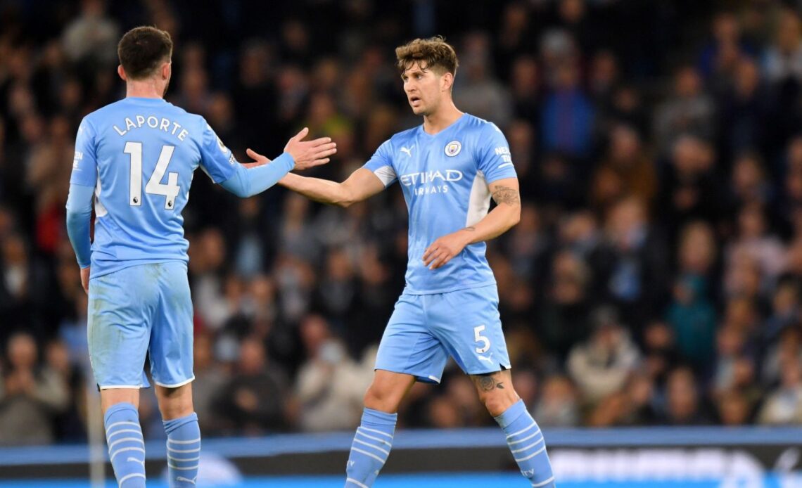 Manchester City defender Aymeric Laporte gives John Stones a high five