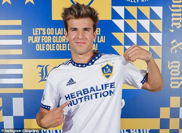 Puig happily smiles and points to Los Angeles Galaxy badge during his unveiling