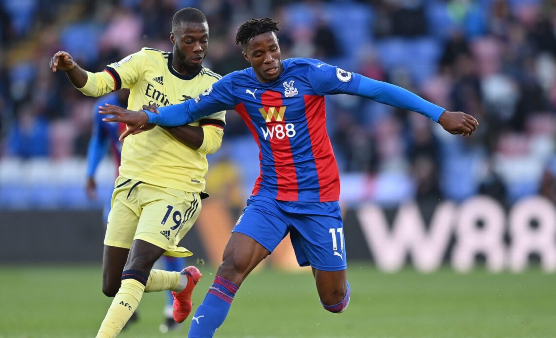 Arsenal winger Nicolas Pepe and Wilfried Zaha compete for the ball
