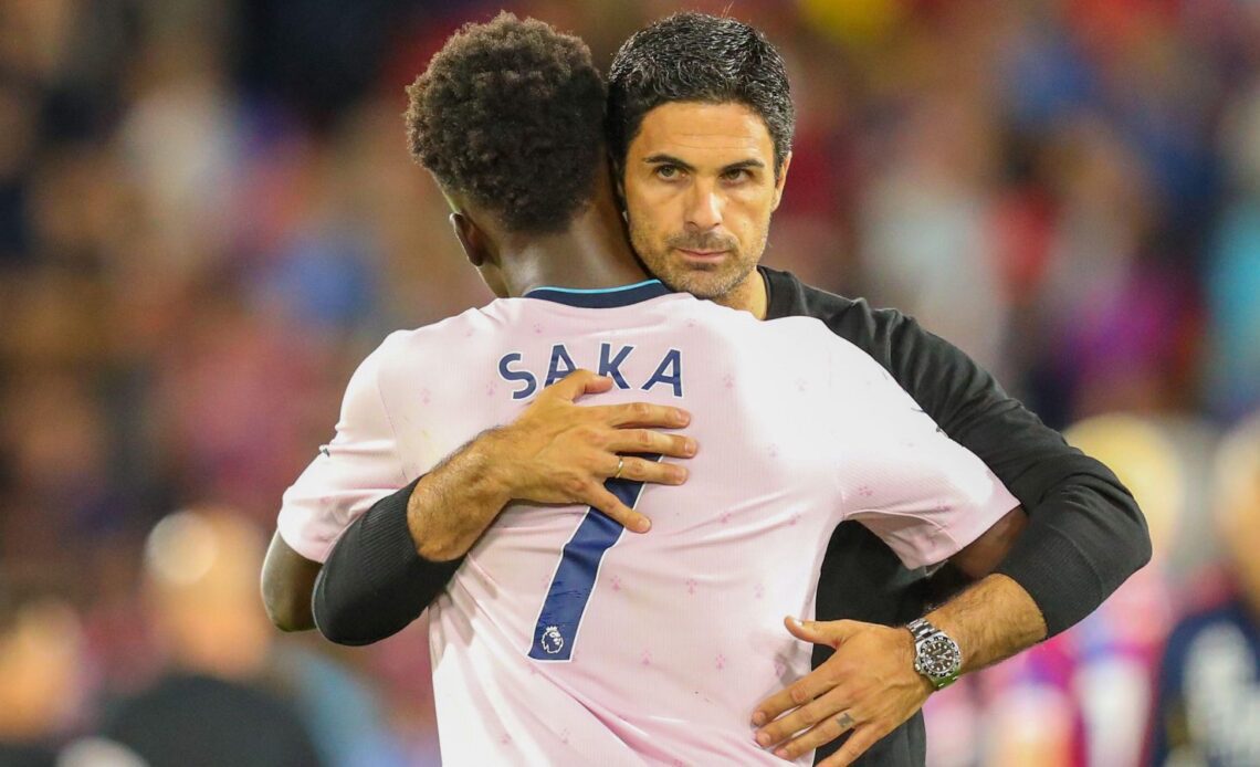 Arsenal manager Mikel Arteta embraces Bukayo Saka.