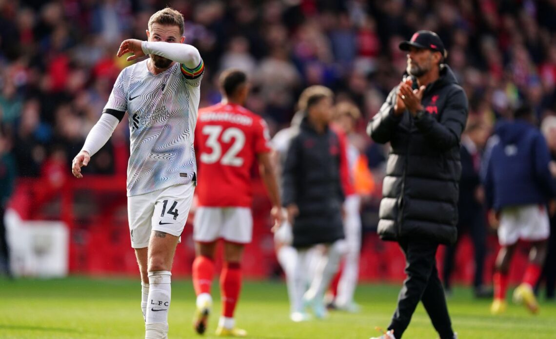 Liverpool captain Jordan Henderson wipes his face with his arm