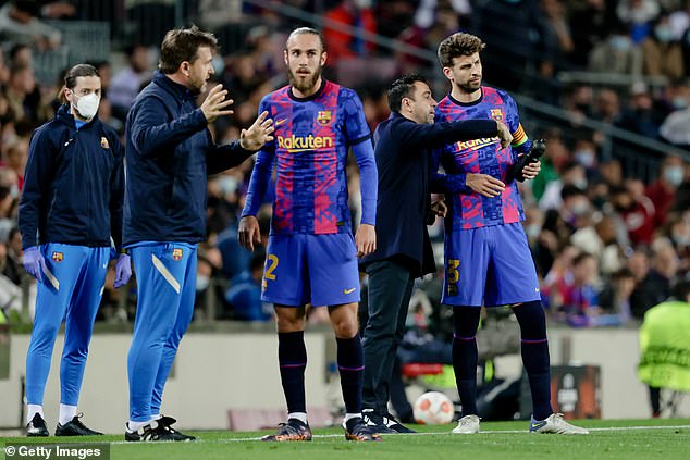Barca manager Xavi (second right) labelled the defender's decision to quit the sport and save the cash-strapped Catalan club a reported £44million 'a gesture of spectacular greatness'