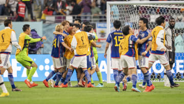 Japan's substitutes celebrate a win decided by Hajime Moriyasu's alterations from the bench