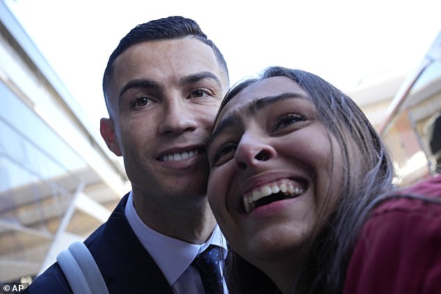 Cristiano Ronaldo is all smiles as he poses for photos with fans ahead of the 2022 World Cup