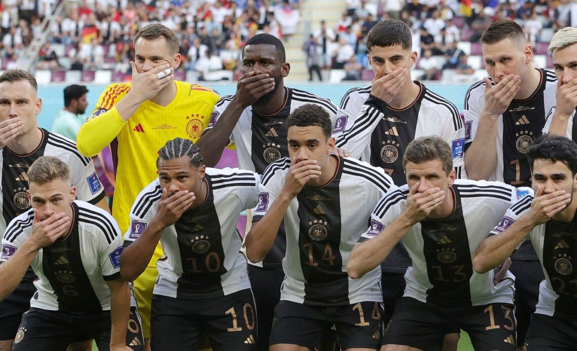 Germany players cover their mouths before a match