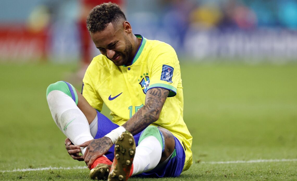 Neymar holds his ankle