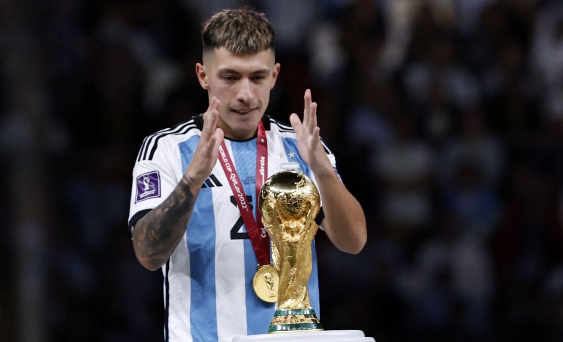 Argentina defender Lisandro Martinez prepares to touch the World Cup trophy