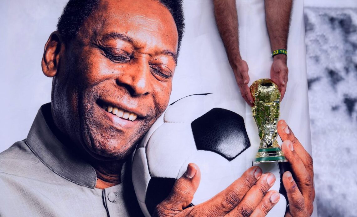 Brazil legend Pele hugs a football in a picture