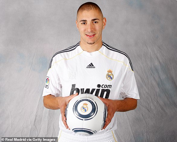Karim Benzema poses in Real Madrid kit after completing his transfer from Lyon
