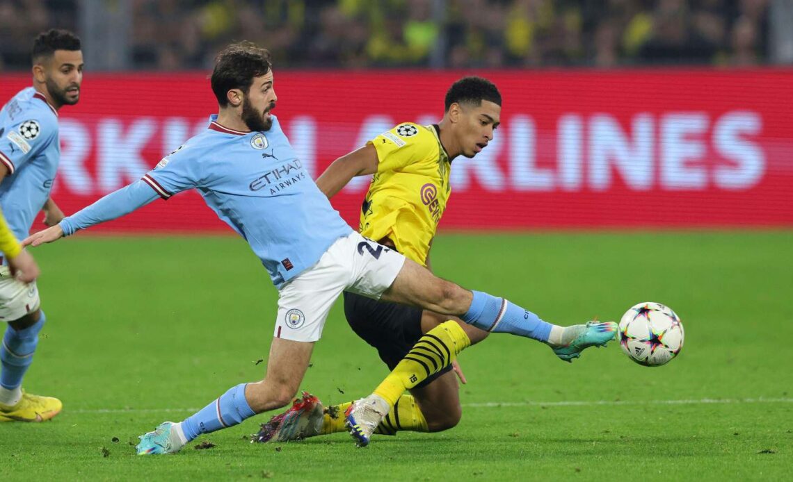 Jude Bellingham and Bernardo Silva battle for the ball