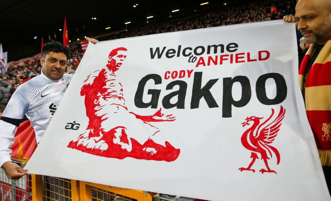 Liverpool fans hold up a banner