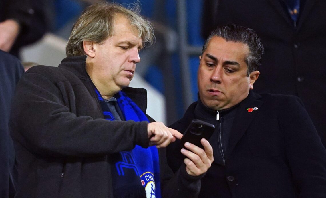 Chelsea boss Todd Boehly shows something on his phone