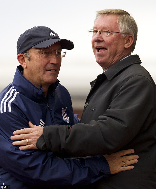 Pulis pictured with Manchester United manager Sir Alex Ferguson during a match in 2011