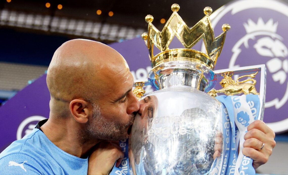 Man City boss Pep Guardiola kisses the Premier League trophy