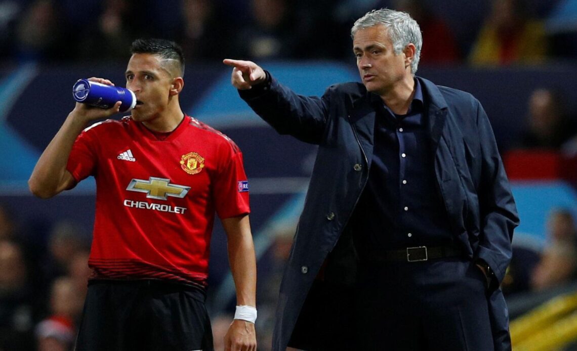 Man Utd forward Alexis Sanchez stands behind Jose Mourinho