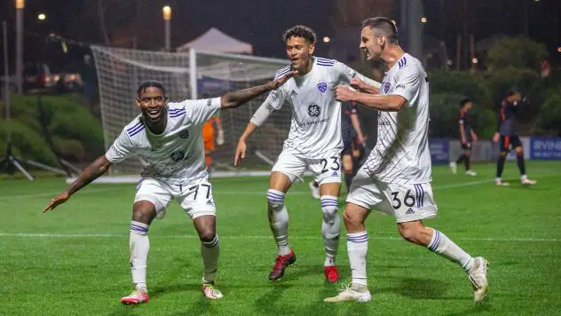 Louisville City FC forward Enoch Mushagalusa and midfielders Elijah Wynder and Paolo DelPiccolo (L to R) celebrate