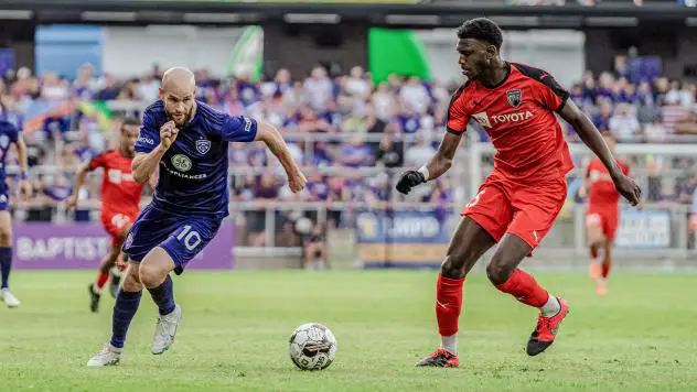 Louisville City FC forward Brian Ownby (left) eyes the ball