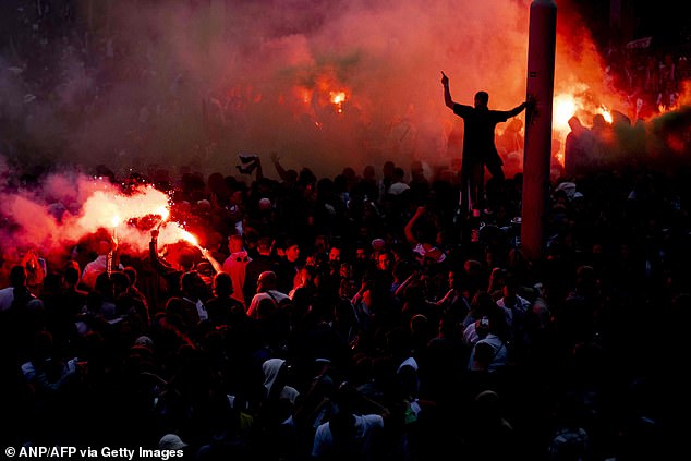 The result sparked wild celebrations (above) from scores of jubilant supporters in Rotterdam