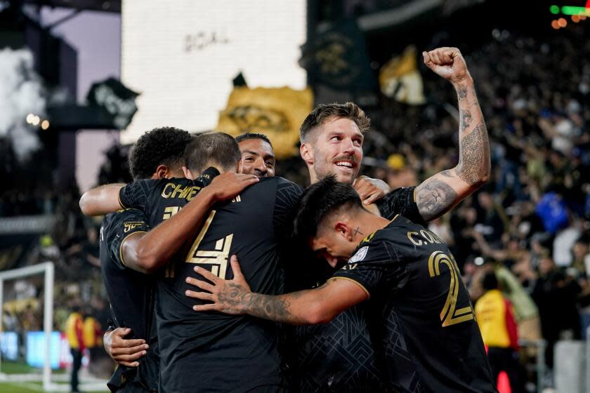 Los Angeles FC midfielder Ryan Hollingshead, top right, is surrounded by teammates.
