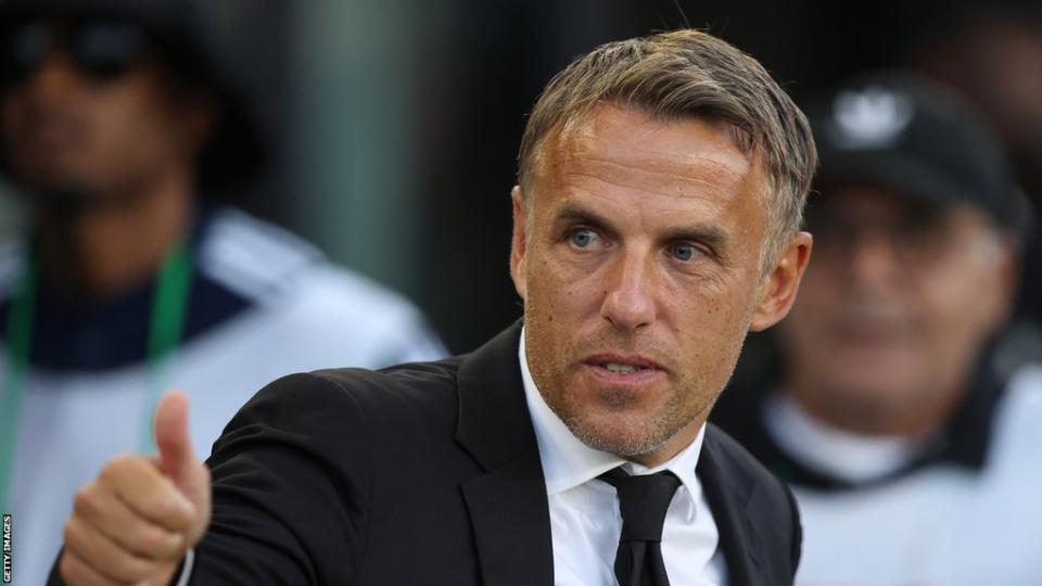 Phil Neville coaches on the sideline during an MLS match