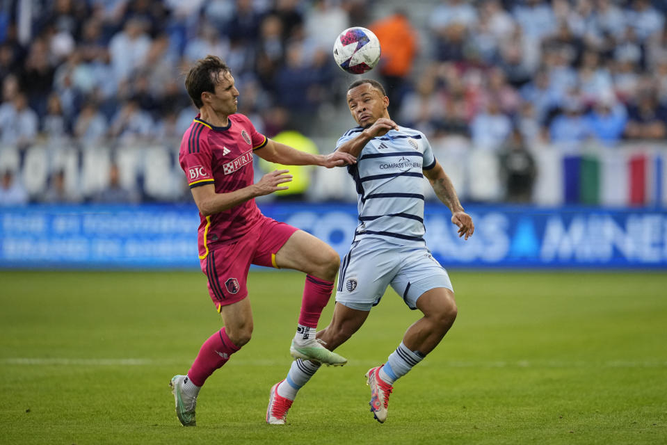 Nov 5, 2023; Kansas City, KS, USA; St. Louis City SC midfielder Jared Stroud (8) battles Sporting Kansas City defender Logan Ndenbe (18) for the ball in the first half of game two in a round one match of the 2023 MLS Cup Playoffs at Children's Mercy Park. Mandatory Credit: Jay Biggerstaff-USA TODAY Sports