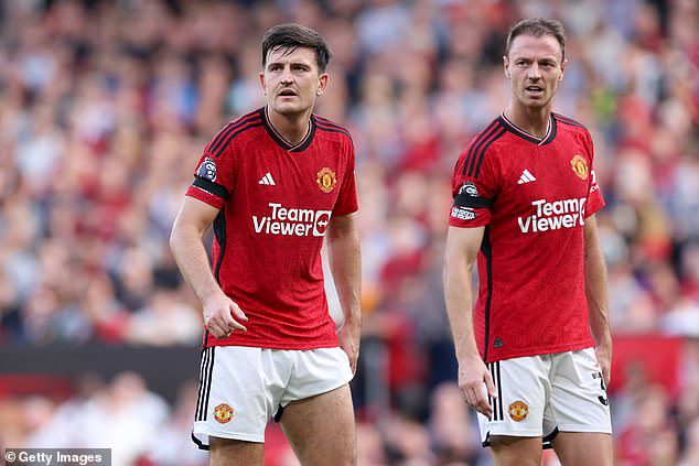 Paul Scholes believes Erik ten Hag has turned to Harry Maguire (left) and Jonny Evans (right) because they're better on the ball than Raphael Varane