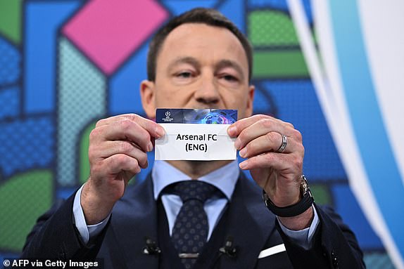 UEFA Champions League ambassador and British former football player, John Terry holds the paper slip of Arsenal FC during the 2023-2024 UEFA Champions League football tournament round of 16 draw at the House of European Football in Nyon, on December 18, 2023. (Photo by Fabrice COFFRINI / AFP) (Photo by FABRICE COFFRINI/AFP via Getty Images)