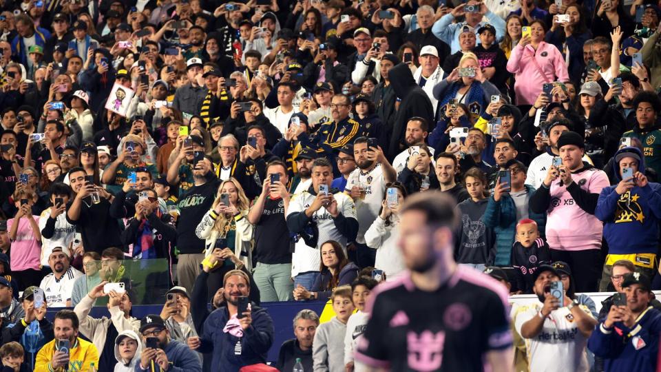 Fans take pictures and video of Miami's Lionel Messi before a corner kick against the Galaxy.