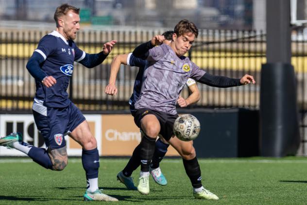 Robbie Mertz of the Pittsburgh Riverhounds dribbles away from Indy Eleven defenders