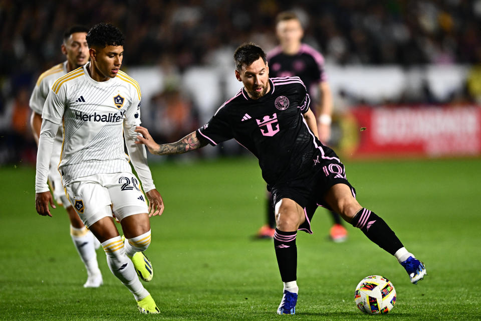 Inter Miami's Argentine forward #10 Lionel Messi fights for the ball with Galaxy's midfielder #20 Edwin Cerrillo during the MLS football match between LA Galaxy and Inter Miami FC at Dignity Health Sports Park on February 25, 2024, in Carson, California. (Photo by Patrick T. Fallon / AFP) (Photo by PATRICK T. FALLON/AFP via Getty Images)