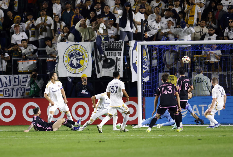 CARSON, CALIFORNIA - FEBRUARY 25: Lionel Messi #10 of Inter Miami scores the equalizer in injury time during the second half against Maya Yoshida #4 of the Los Angeles Galaxy at Dignity Health Sports Park on February 25, 2024 in Carson, California. (Photo by Kevork Djansezian/Getty Images)
