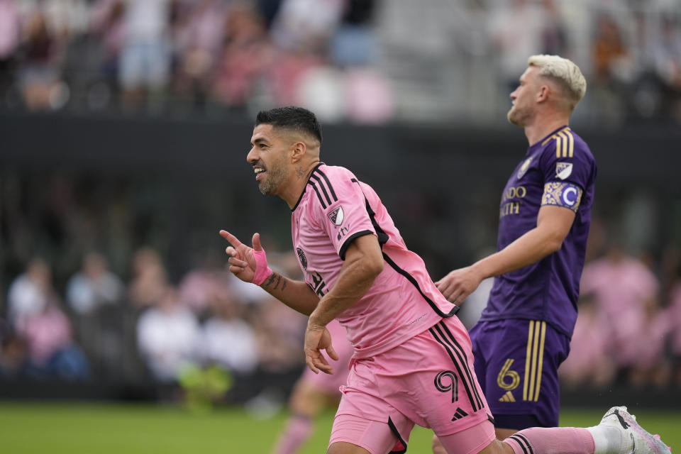 Inter Miami forward Luis Suarez (9) runs past Orlando City defender Robin Jansson (6) as he celebrates after scoring his side's second goal during the first half of an MLS soccer match, Saturday, March 2, 2024, in Fort Lauderdale, Fla. (AP Photo/Rebecca Blackwell)