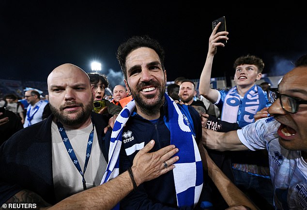 Fabregas pictured (center) celebrating in May after Como secured promotion from Serie B