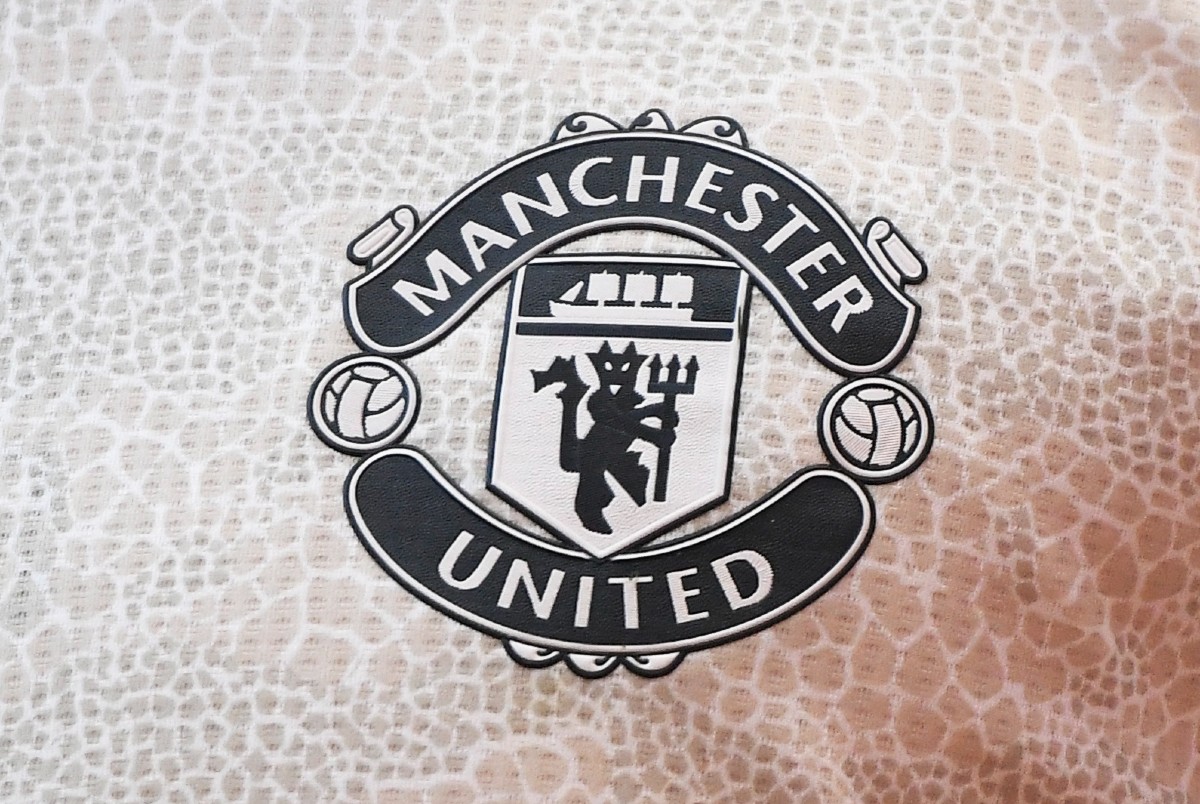 The Manchester United badge on a white shirt