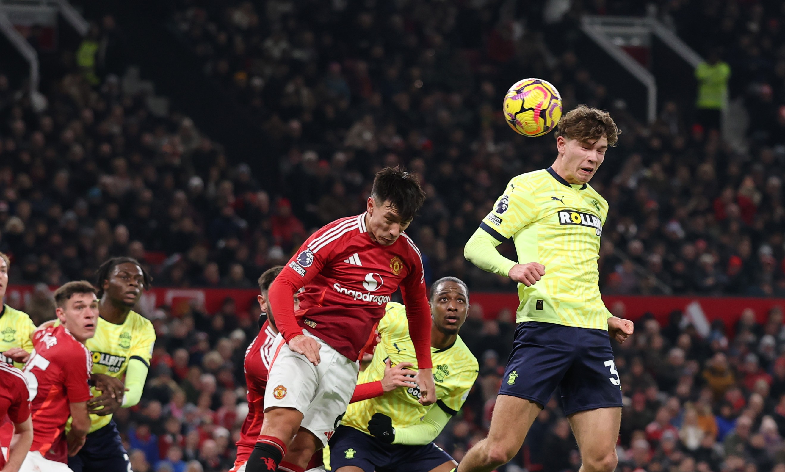 Tyler Dibling of Southampton has a headed shot deflected by Manuel Ugarte of Manchester United.